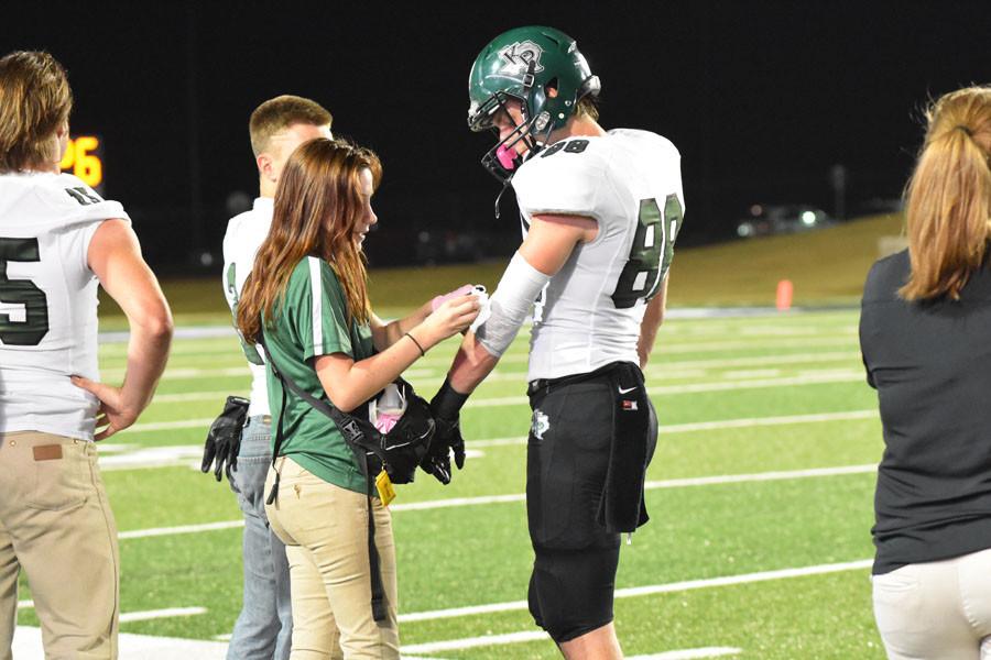 Junior Meghan Jackson works as a student trainer during the varsity football game against Porter on Oct. 23. In the third quarter with the Panthers leading 31-7, Jackson wrapped Zach Mills arm in between plays. 
