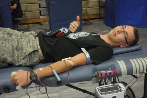 Junior Aaron Keith gives blood at the blood drive on September 15.