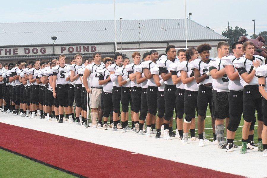 K-Park varsity football stands for the national anthem for the game against Magnolia on August 26th.
