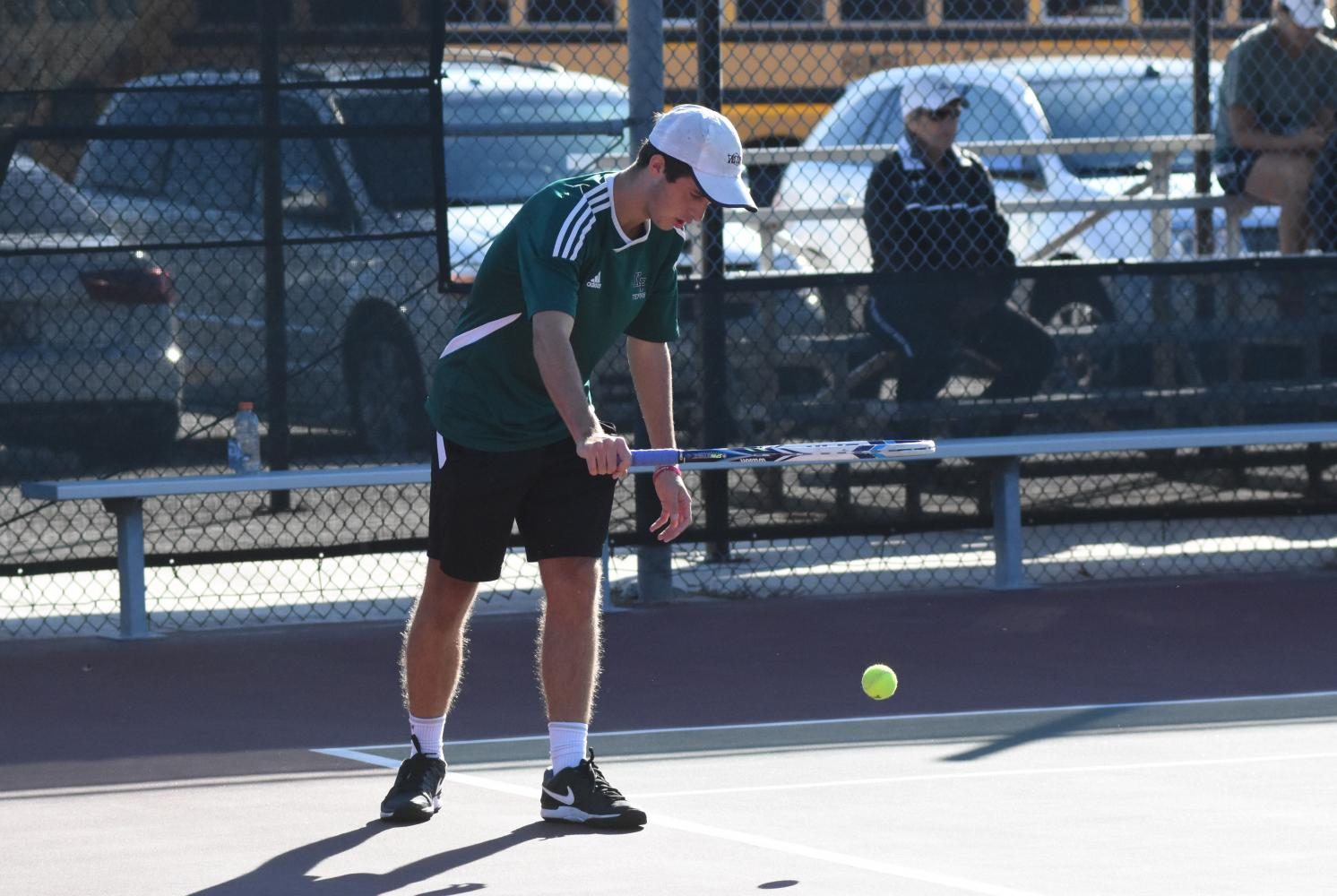 Guynes bounces a tennis ball before a serve during a tournament at K-Park.