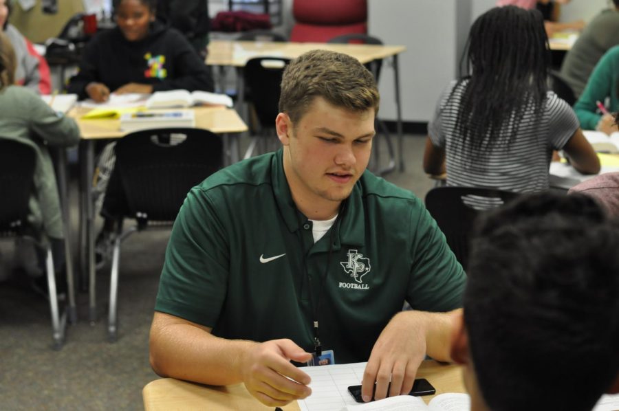 Junior Ronan Keeler works on a group project in English III. After transferring from St. Martha, Keeler has found his groove in the classroom and on the field.