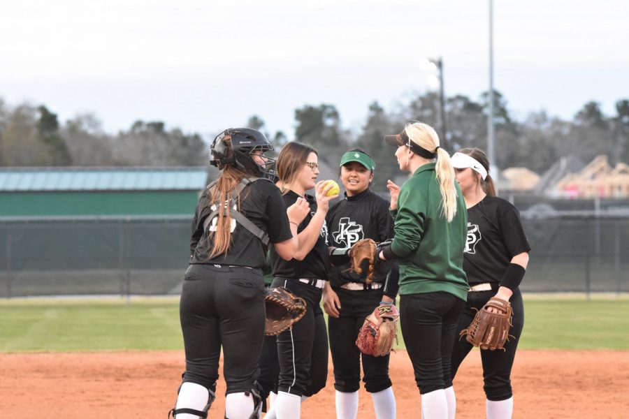 The infield huddles on the mound during the first scrimmage of the year.