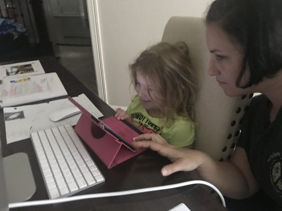 Earlier this month, algebra teacher Kathryn Espinosa sits with her 6-year-old daughter Lilly as she works on her kindergarten homework. 
