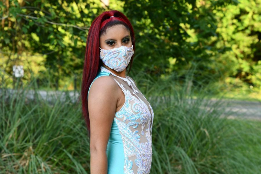 Senior Crystal Vargas poses at Deer Ridge park in her prom dress and a matching face mask.