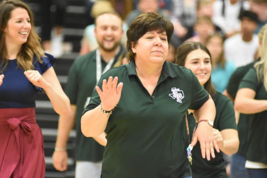 Chemistry teacher Laurie Rosato participates in the teacher dance during the first day of school pep rally. 