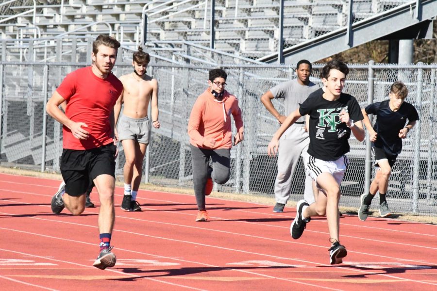 During seventh period track practice on Jan. 14, the boys track team warms up. Many are looking forward to finally hitting the track again since last season was cut short because of COVID-19.