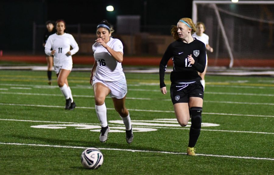 Sophomore Emma Yeager dribbles up the field and looks for a teammate to cross to against Klein Collins on Jan. 12. The Panthers tied Klein Collins 1-1.