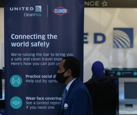 A sign informs travelers on COVID-19 guidelines at the United Airlines check-in area in Terminal 1 at OHare International Airport in Chicago on Nov. 12.