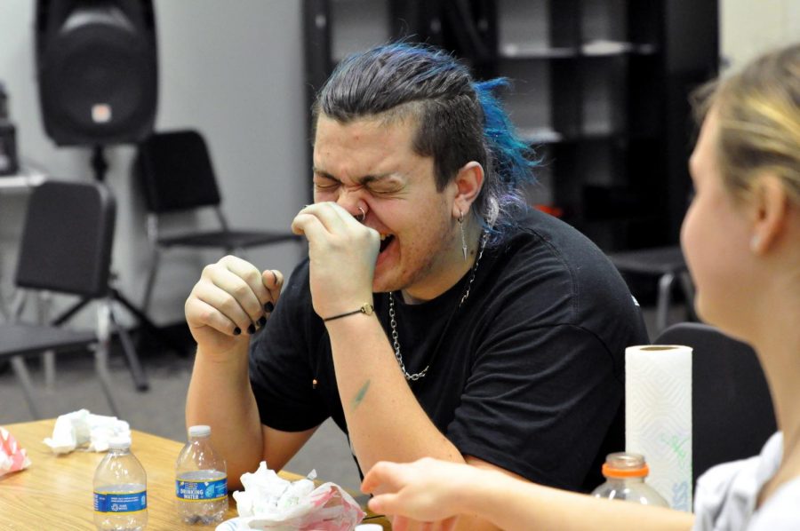 Aaron Dhooghe laughs as the final round of the choir burrito eating competition comes to an end on Jan. 14. He won the finals. “It was kind of silly,” Dhooghe said. “I thought it would be fun to do because a lot of my friends say I eat really fast.”