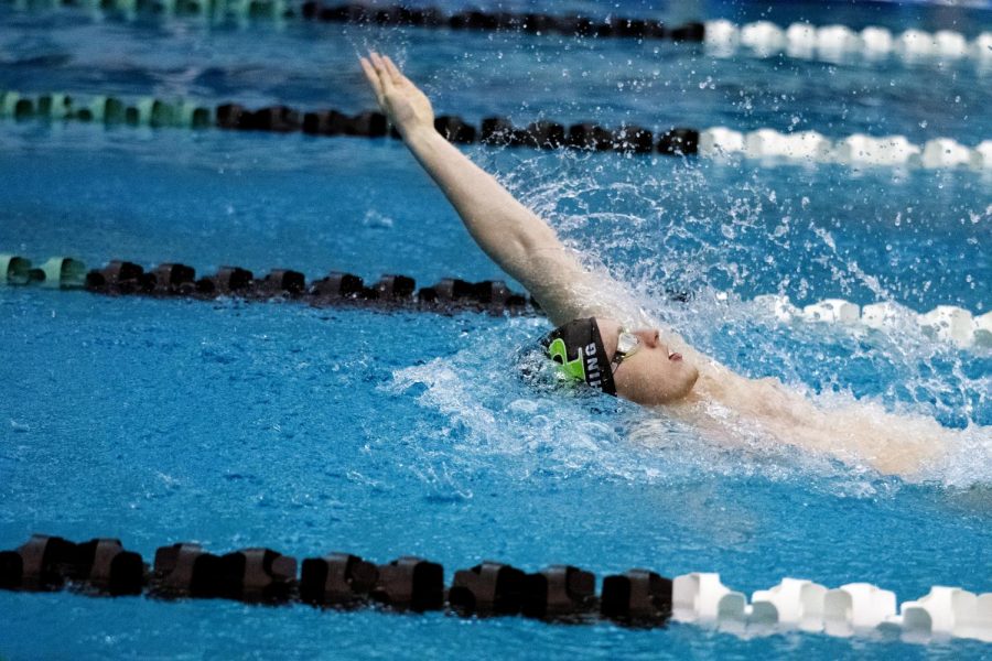 Senior+Logan+Rushing+competes+in+the+100+backstroke+on+Jan.+8+in+the+final+home+meet+of+the+season.+