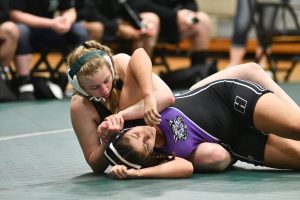 Senior Maddie Sandquist turns her Humble opponent as she gets ready to pin her on March 10. Sandquist is ranked No. 1 in the state. 