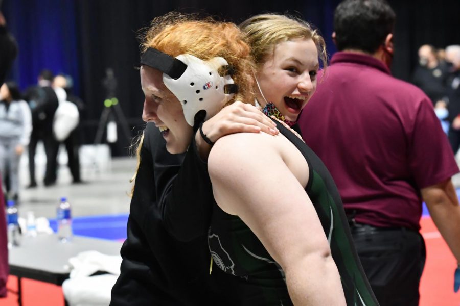 Junior Lexi Shannon celebrates with senior Maddie Sandquist after Shannon won her first state title. 