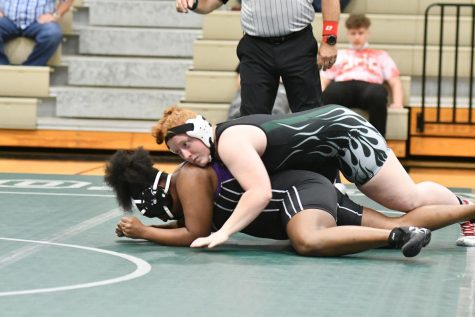 Junior Lexi Shannon works to turn an Humble opponent before pinning her. Shannon will wrestle in her third state championship meet on April 23.