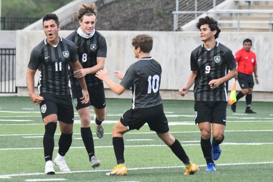 Gage Guerra, 12, celebrates with Nathan Jimerson, 12, Trey Ricker, 11, and Julian Guerra, 11, after scoring the first goal of the game against Foster in the regional semifinal.