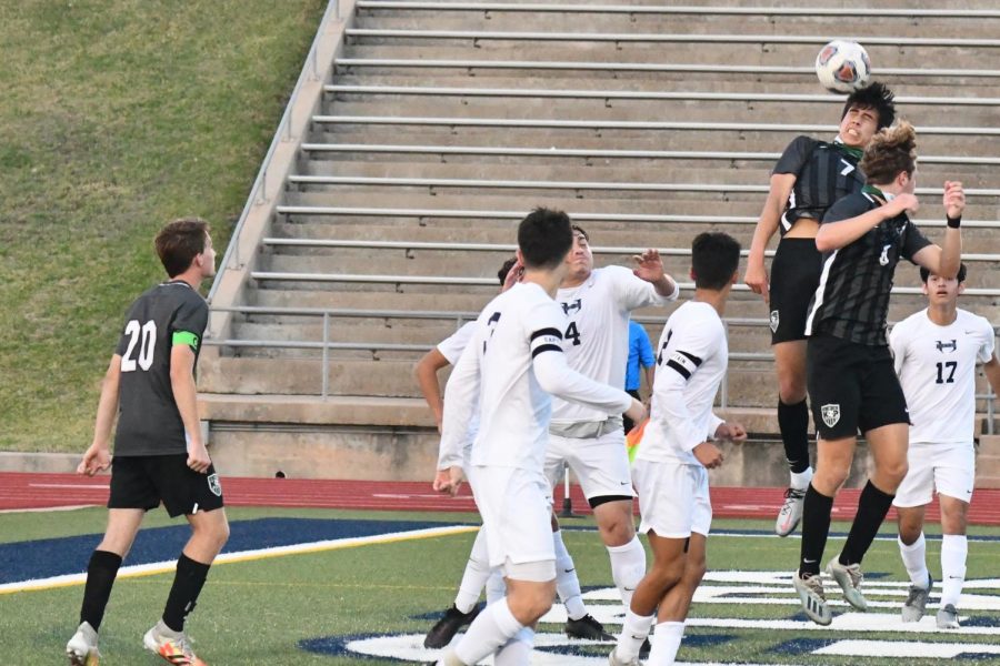 Senior Jesus Cervantes heads the ball near the Panthers' goal against Hendrickson on April 9. 