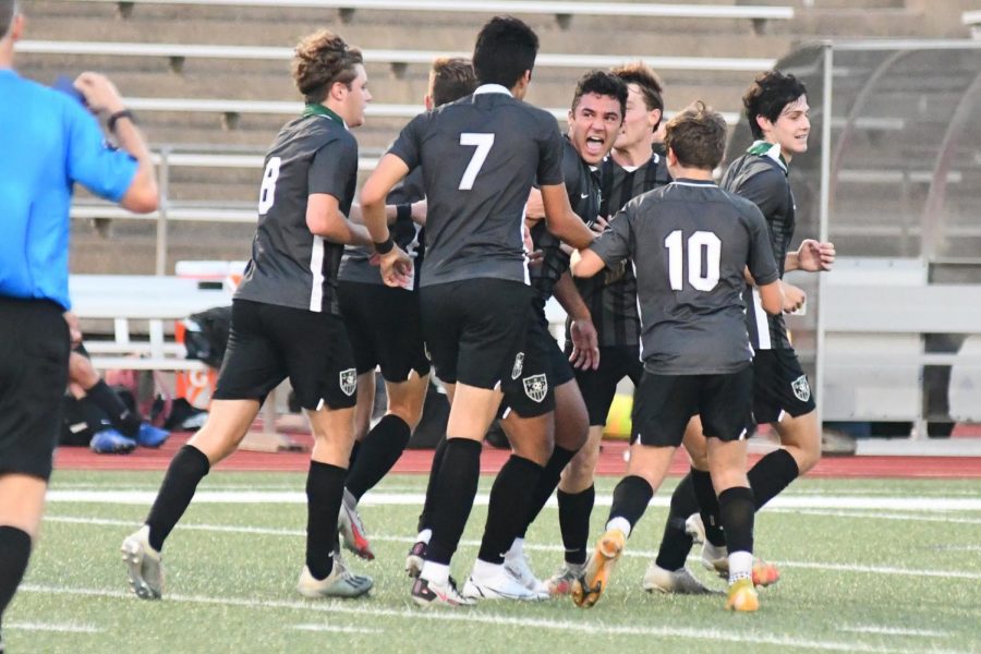 Senior Gage Guerra celebrates with his teammates after scoring on a header with less than a minute to play in the first half. The goal put the Panthers up 3-2. 