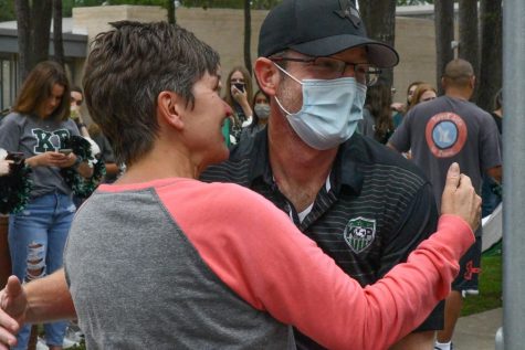 Danika Yeager, mom of goalkeeper Thor Yeager, wishes coach Ryan Searle good luck as he gets ready to return to the bus during the teams send off on Friday afternoon. 