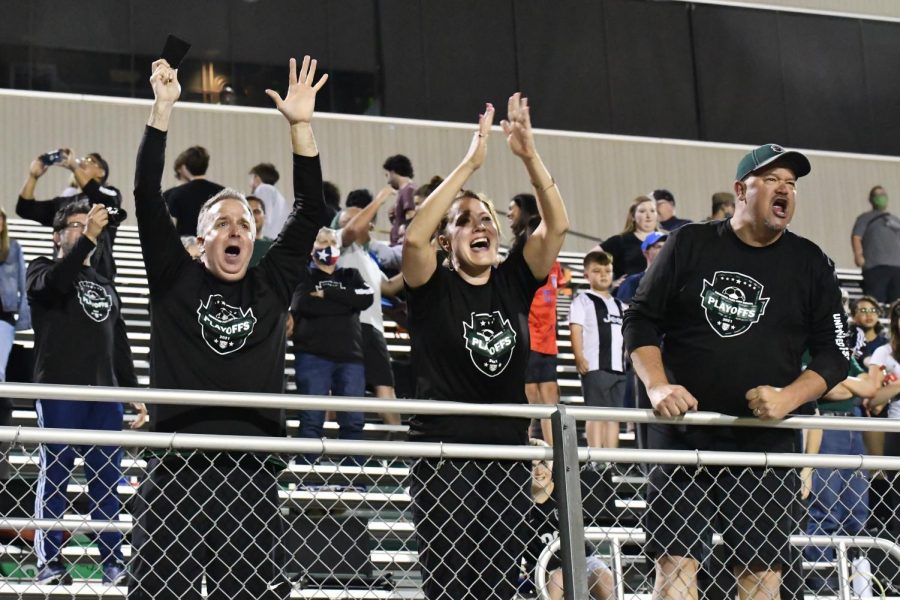 Parents cheer at the railing as they celebrate the boys soccer teams 5-4 victory over Pharr Valley View in the state semifinals. Despite games being so far away, the families and Kingwood Park community have traveled to watch the team play.
