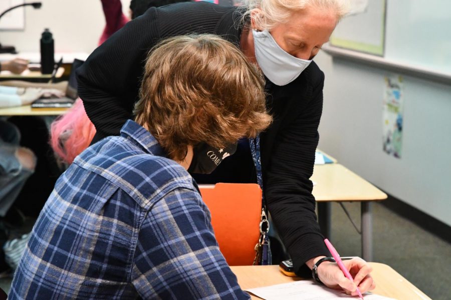 Algebra teacher Nancy Doehring helps a student during her seventh period class. 