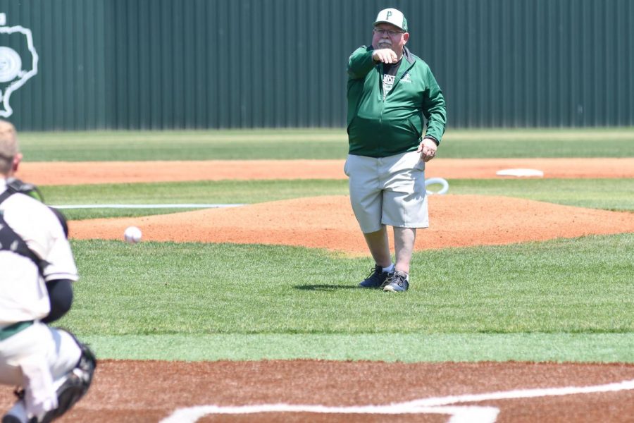 Science teacher Joe Ehrhardt throws out the ceremonial first pitch prior to the Dayton game on April 24. Ehrhardt is retiring after 42 years in education.