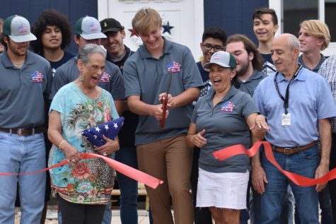 Lead architect Parker Ryan cuts the red ribbon at the ceremony on April 28 at Kingwood Park. The house was moved to Liberty County the next day.