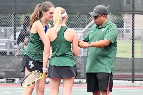 Sophomore Brooke OBrien and teammate Makenna Cottle talk with coach John Macapaz between games against MacArthur on Aug. 13.