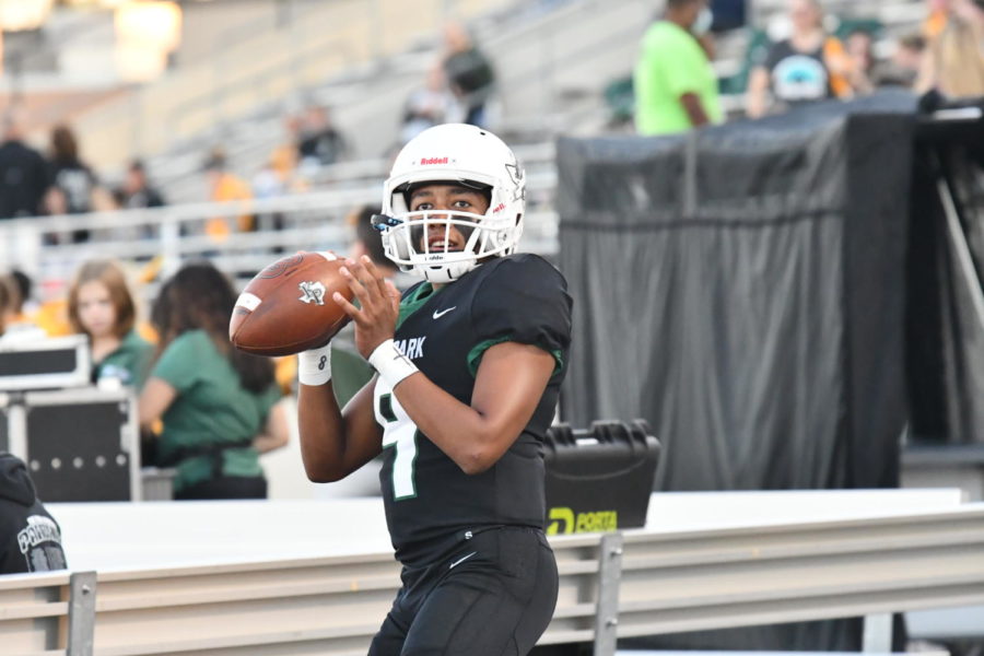 Sophomore Jaxon Sims warms up before a football game. 