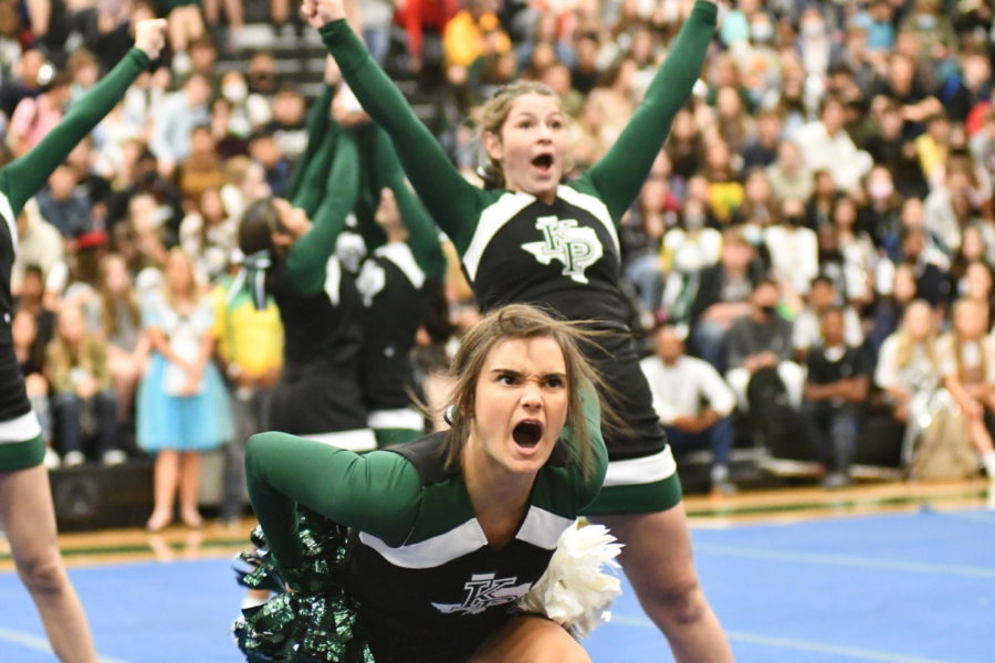 Molly Scott, 12, performs with the other cheerleaders as they kick off the pep rally with a routine to fire up the students at the homecoming pep rally on Oct. 15. 