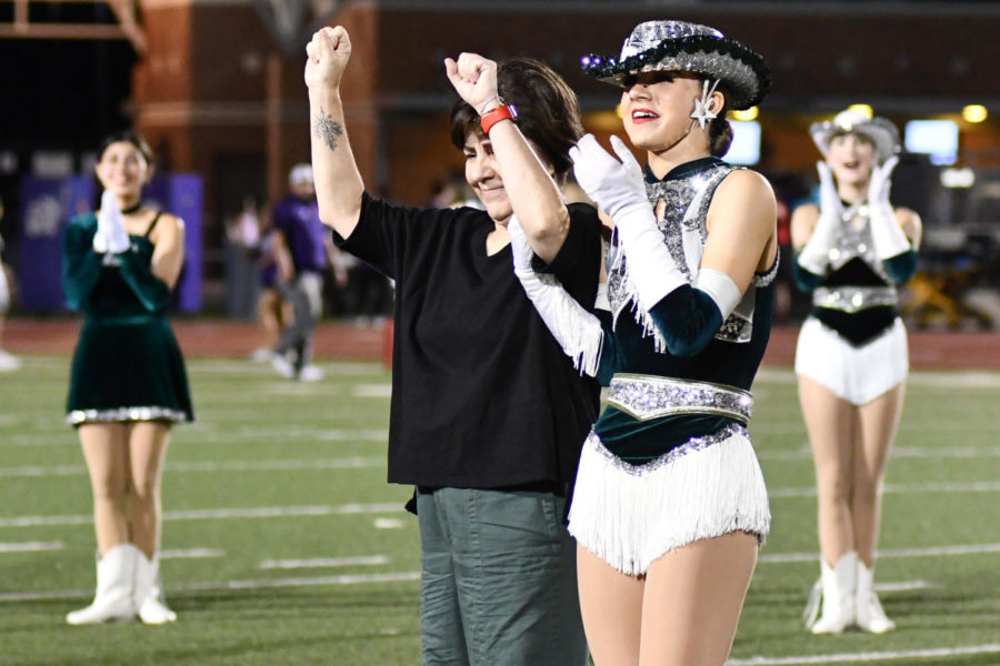 Senior Charlee Poulin and her mom celebrate after hearing Poulins name announced as the senior class homecoming queen at the football game on Oct. 15. 