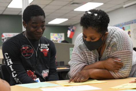 Isaiah Junior, 10, works on his course selection paperwork with teacher Rolanda Wilkins during Intro to Culinary Arts on Jan. 10. Teachers met with students individually to help them select courses for the upcoming school year. 
