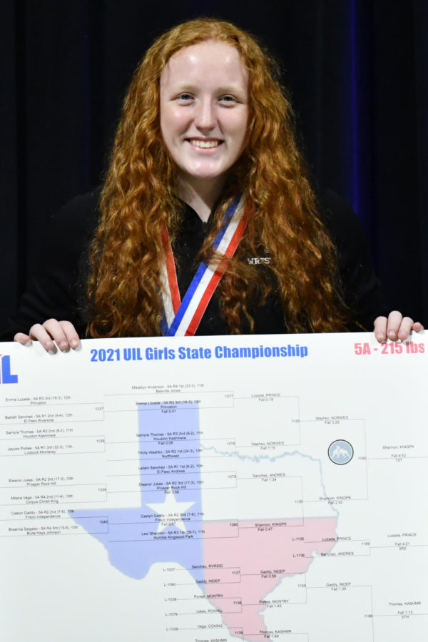 Lexis Shannon holds the 215-pound UIL State Championship bracket on the medal stand after winning the state title last spring. 