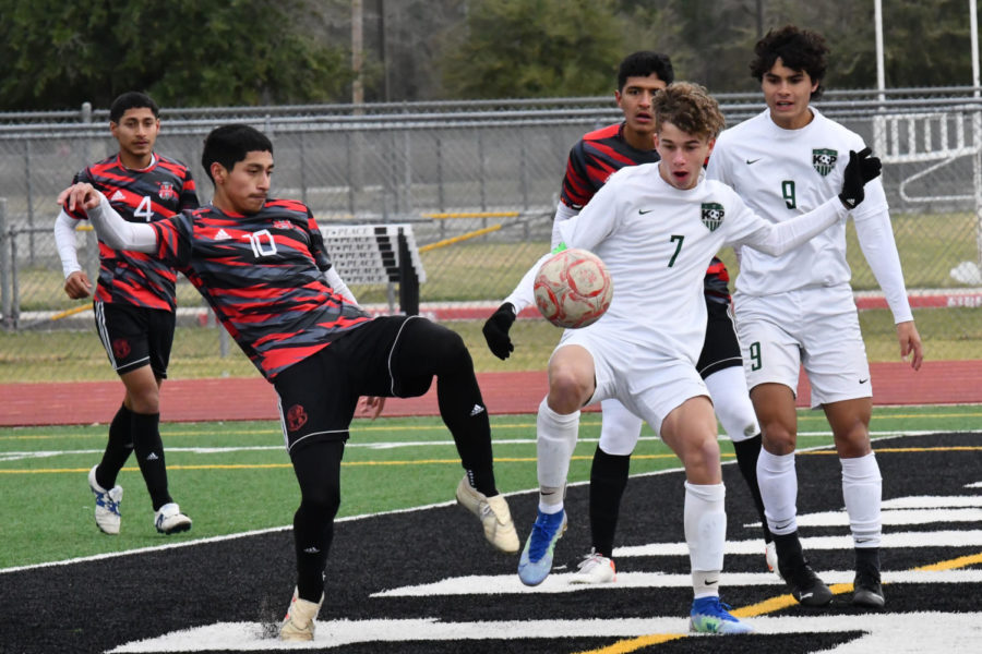 Junior Walter Rodee battles with an Aldine MacArthur defender as senior Julian Guerra is nearby for support. The two teams played on Jan. 15 and tied 2-2. 