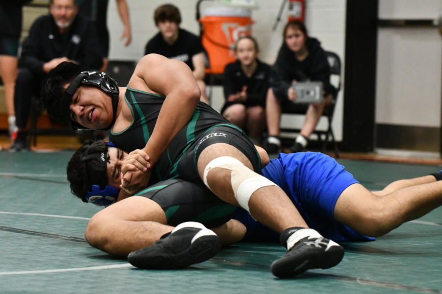 Alex Jasso, 9, attempts to pin his opponent during a match. Jasso placed second at district and competed at the regional level after only one season of wrestling.