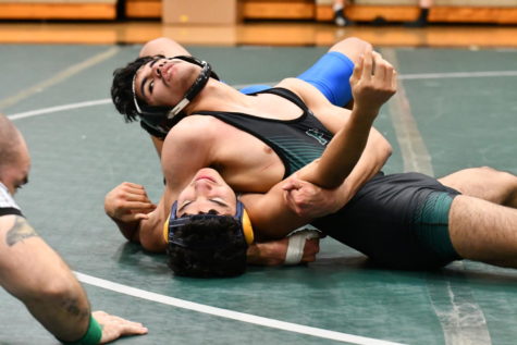 Christian Valencia, 12, pins his opponent during a match. Valencia was a district champion, a regional qualifier and was recognized during that night’s senior celebration.