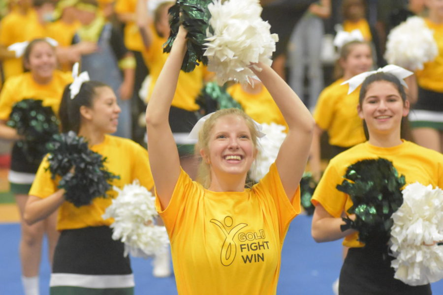 Senior Rachel Morris fires up the crowd at a pep rally earlier this year. Once football season ended, the cheerleaders still cheered on the basketball teams but also focused on preparing for their competition season.