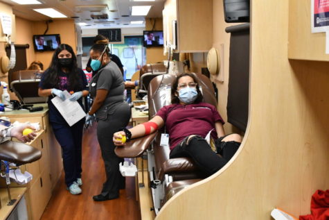 Junior Victoria Ramos donates blood in the Gulf Coast Regional Blood Center van. HOSA organizes four blood drives each year. 