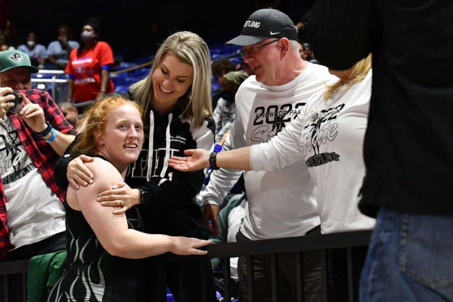 Two-time state champion Lexi Shannon celebrates with her sister, dad and mom after winning the state title on Feb. 19. 