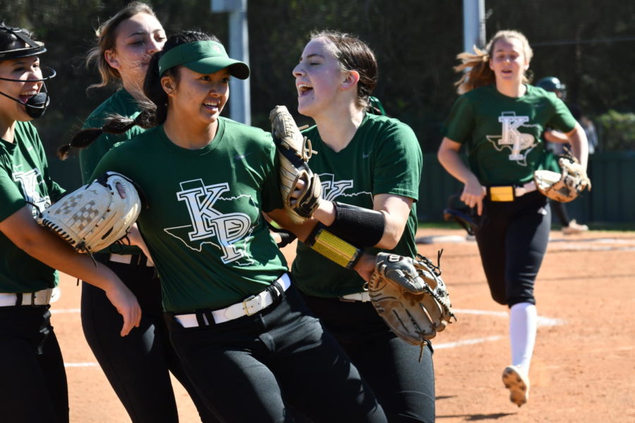 Teammates celebrate Taysia Constantino after she made a play to end the inning against Livingston.