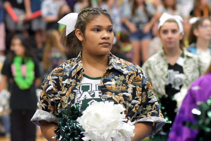 Sophomore Daisha George looks for her cue as the cheerleaders prepare for a pep rally performance on Aug. 27. 