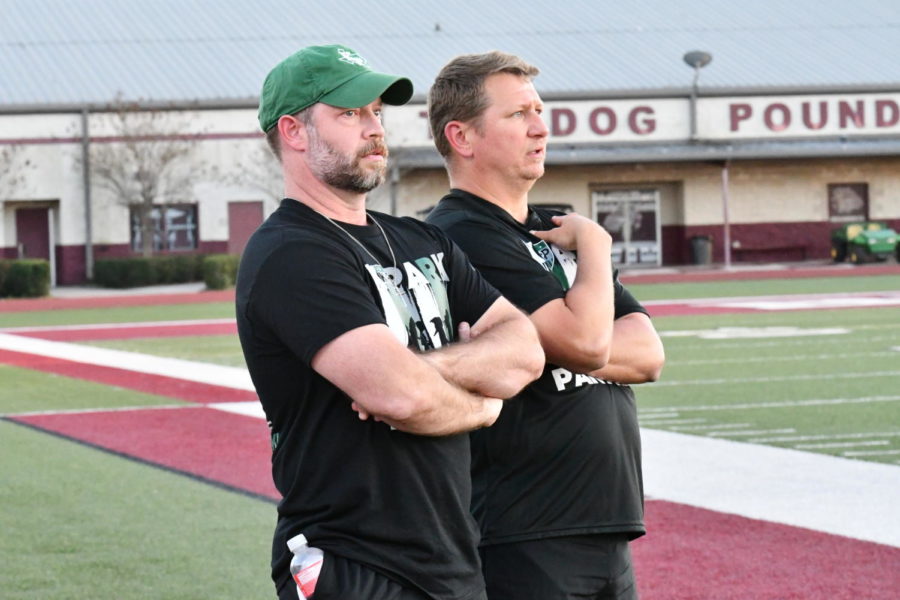 Coach Jess White and Luke Gorney watch from the sidelines during the teams bi-district championship against College Station on March 24.