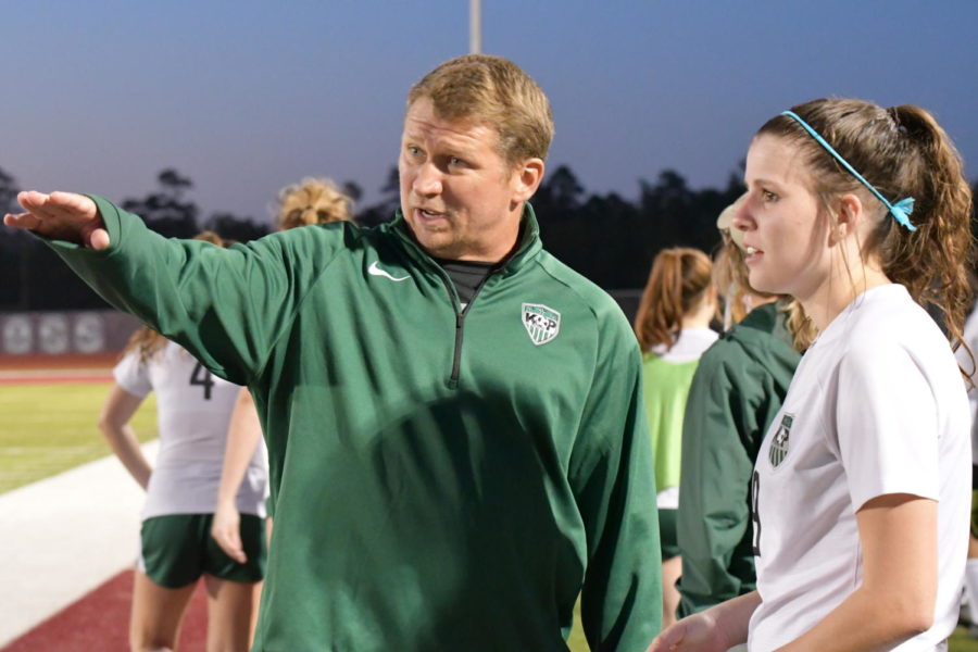 Assistant coach Luke Gorney talks with junior Liv Roach during the soccer team's first-round playoff game against College Station on March 22. 