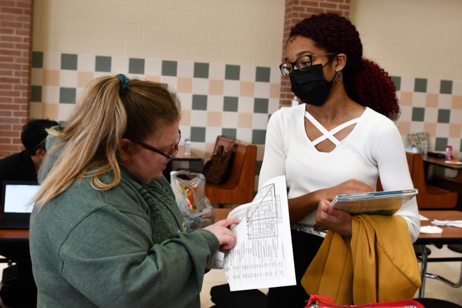 UIL academic team sponsor Aline Theriot helps point Samia Wilson, 10, in the right direction of her competition at Porter High School.