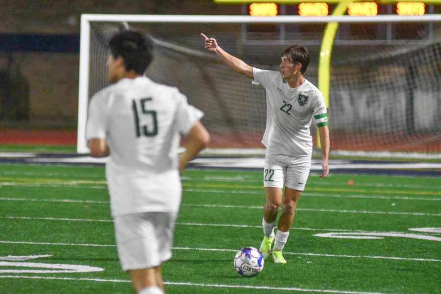 Senior Tony Sterner helps direct his teammates as he moves the ball on defense against Kingwood High School. 