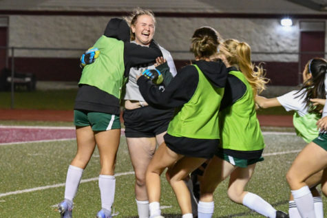 Players race to celebrate with freshman Courtney Daniel, who was in goal during the penalty shootout on March 24 against College Station. 