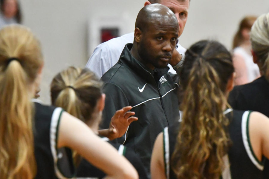 Assistant coach Andrew Cross talks during the huddle of the varsity girls basketball game against Magnolia West on Nov. 9. It was Crosss second season with the team.