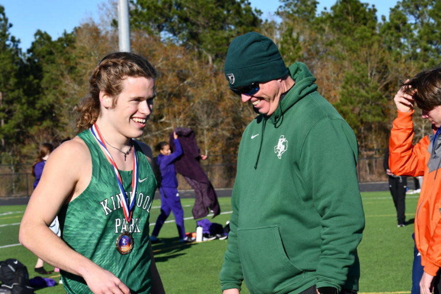 Solomon Karash celebrates with coach Chris Elliott at the end of the Grand Oaks Invitational early in the track season. 