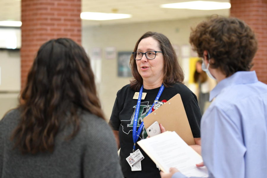 French teacher Beverly Randall talks with sophomore Maya Ortiz and junior Ryan Eckerty during the French Symposium on April 2. 