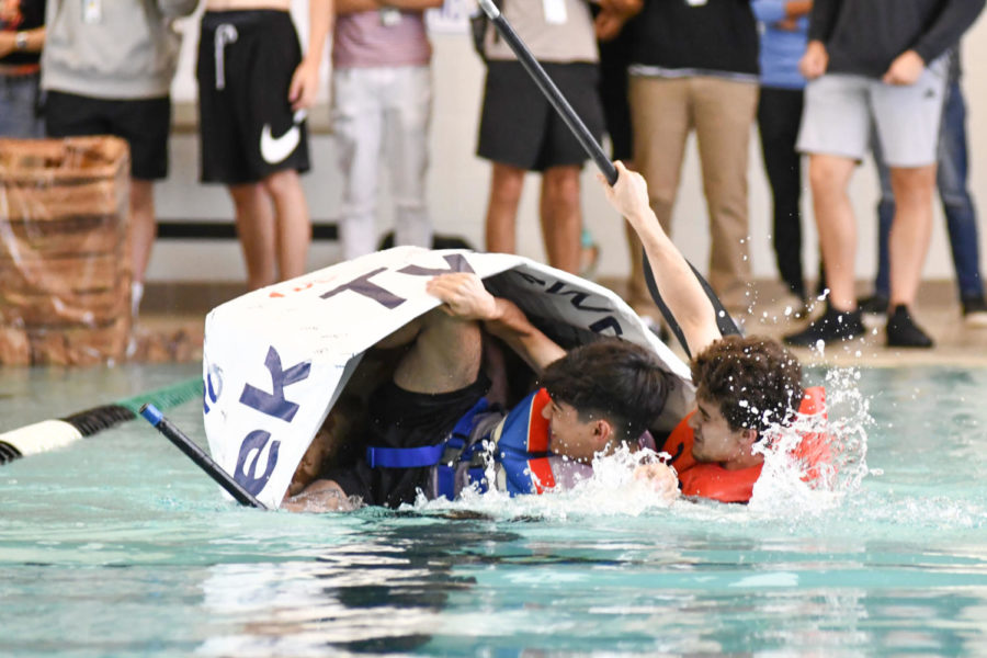 Junior Davey Ramirez and senior Michael Smith tip over during their fourth period boat race.