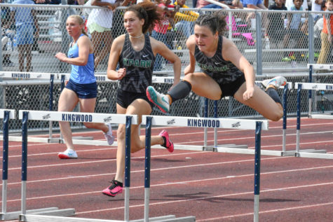 Sophomore Eva Abshire  competes with senior Charlee Jordan at a meet earlier this season. Abshire will compete in the 100 and 300 hurdles at the Regional track meet.