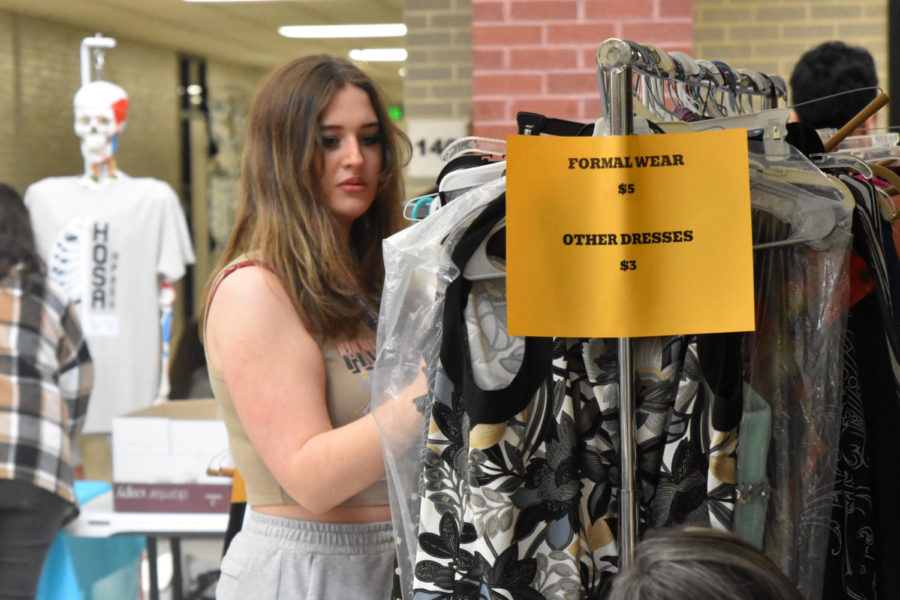 Junior Reese Huchingson looks at the formal wear rack during the Flex Market.